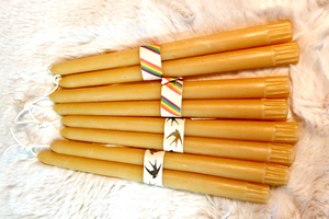 4 pairs of 10" taper candles bundled into pairs on a background of white fur