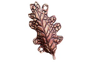 sculpted ceramic oak leaf on a white background