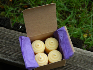 a box of four votive candles
