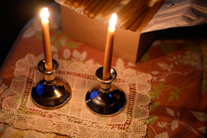 shabbat candles are lit on a table next to a full box of candles